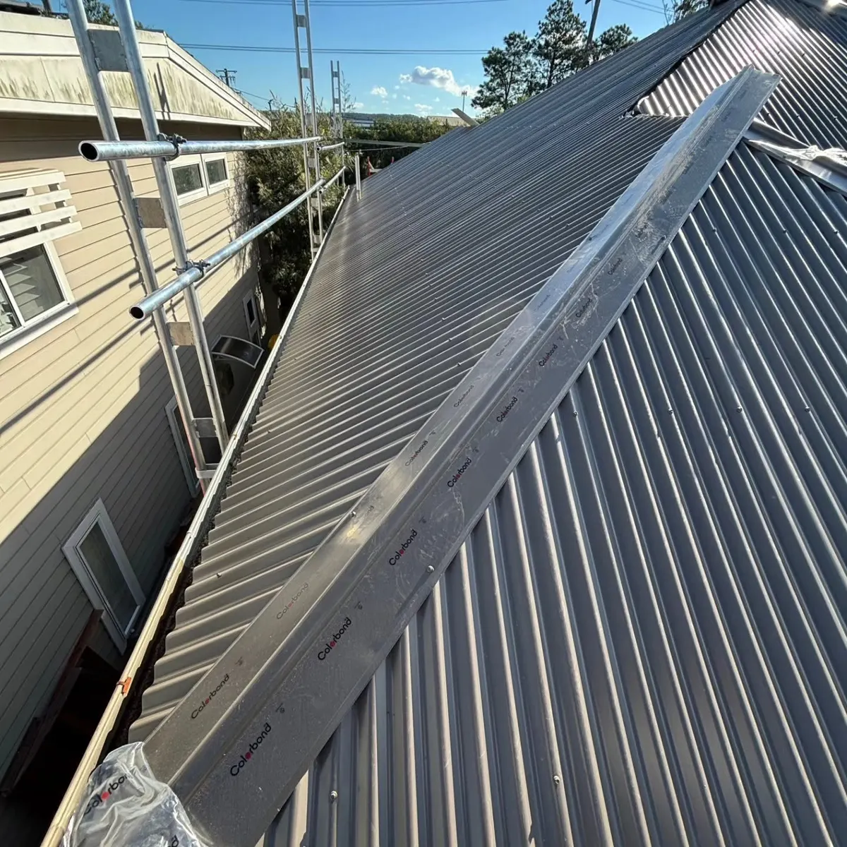 Dark corrugated roof finished along a narrow side wall