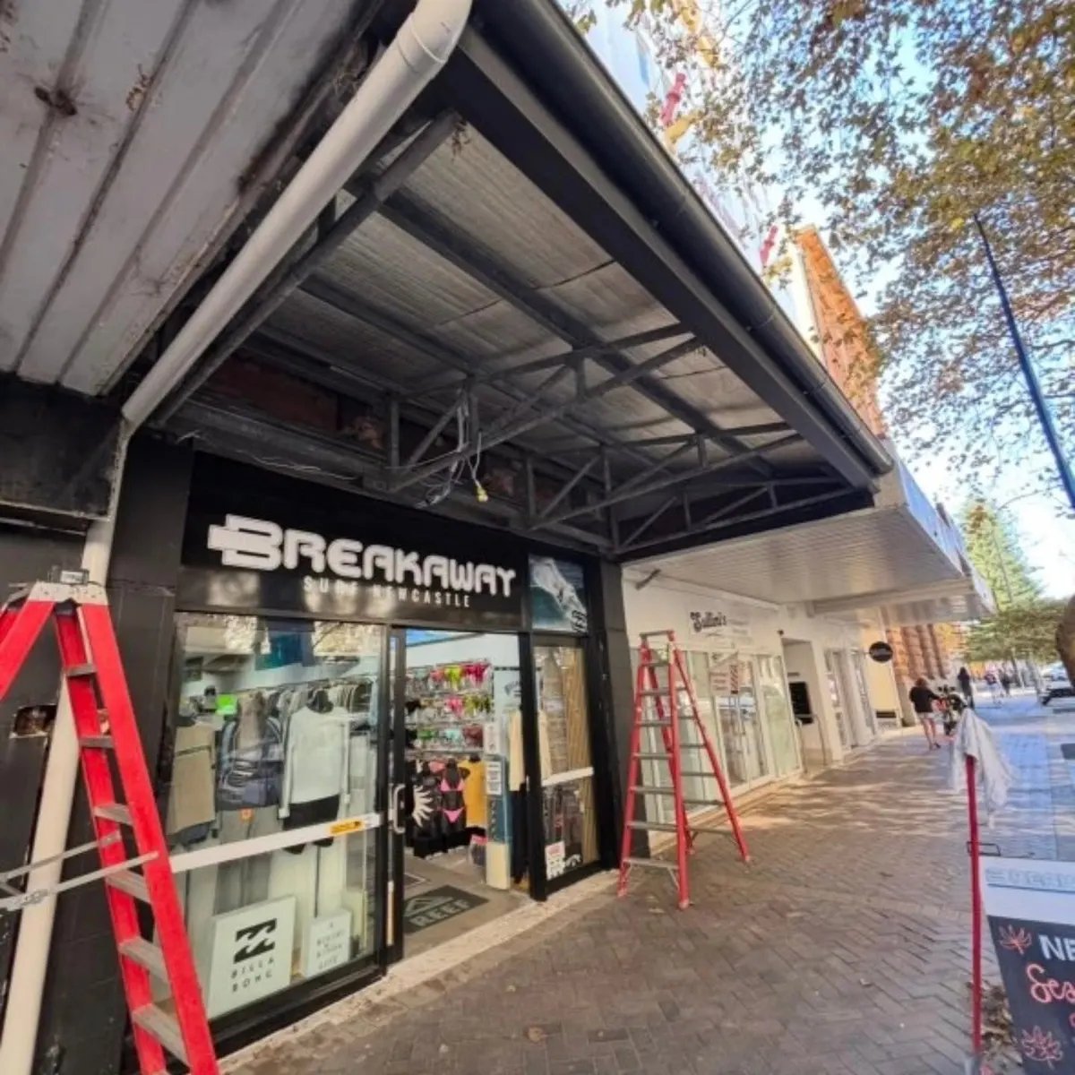 Shopfront awning work underway above the footpath