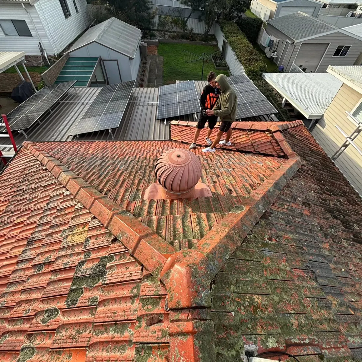 Looking over a mossy terracotta roof before re-roofing
