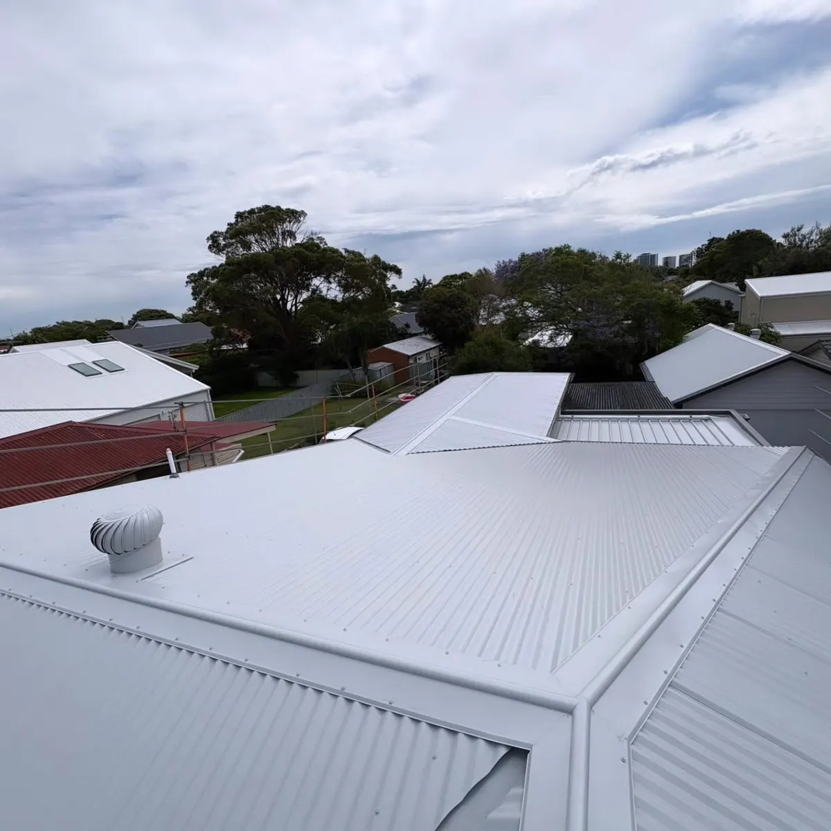 White corrugated roof finished around a whirlybird